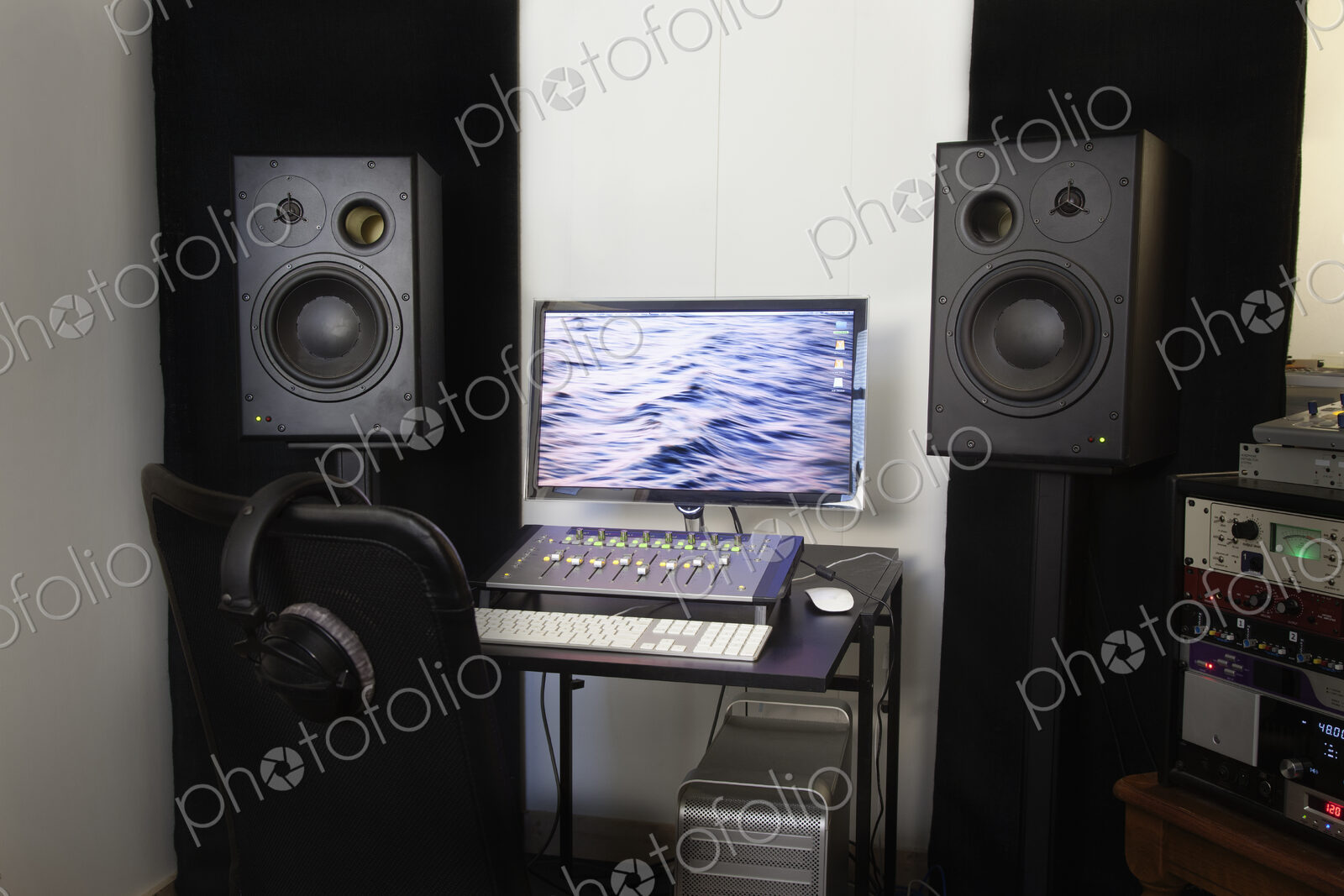 A computer workstation with sound board, speakers, headphones, recording deck and…