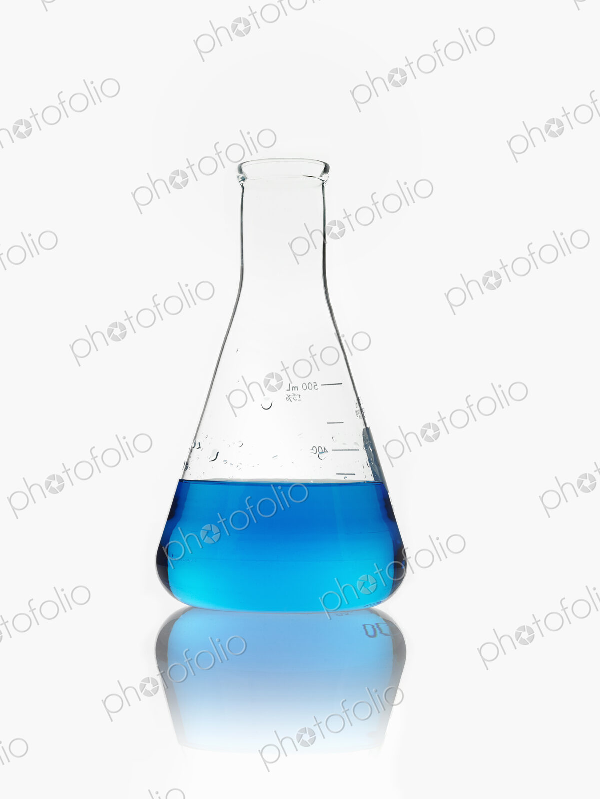 A conical scientific glassware flask partly filled with blue liquid.
