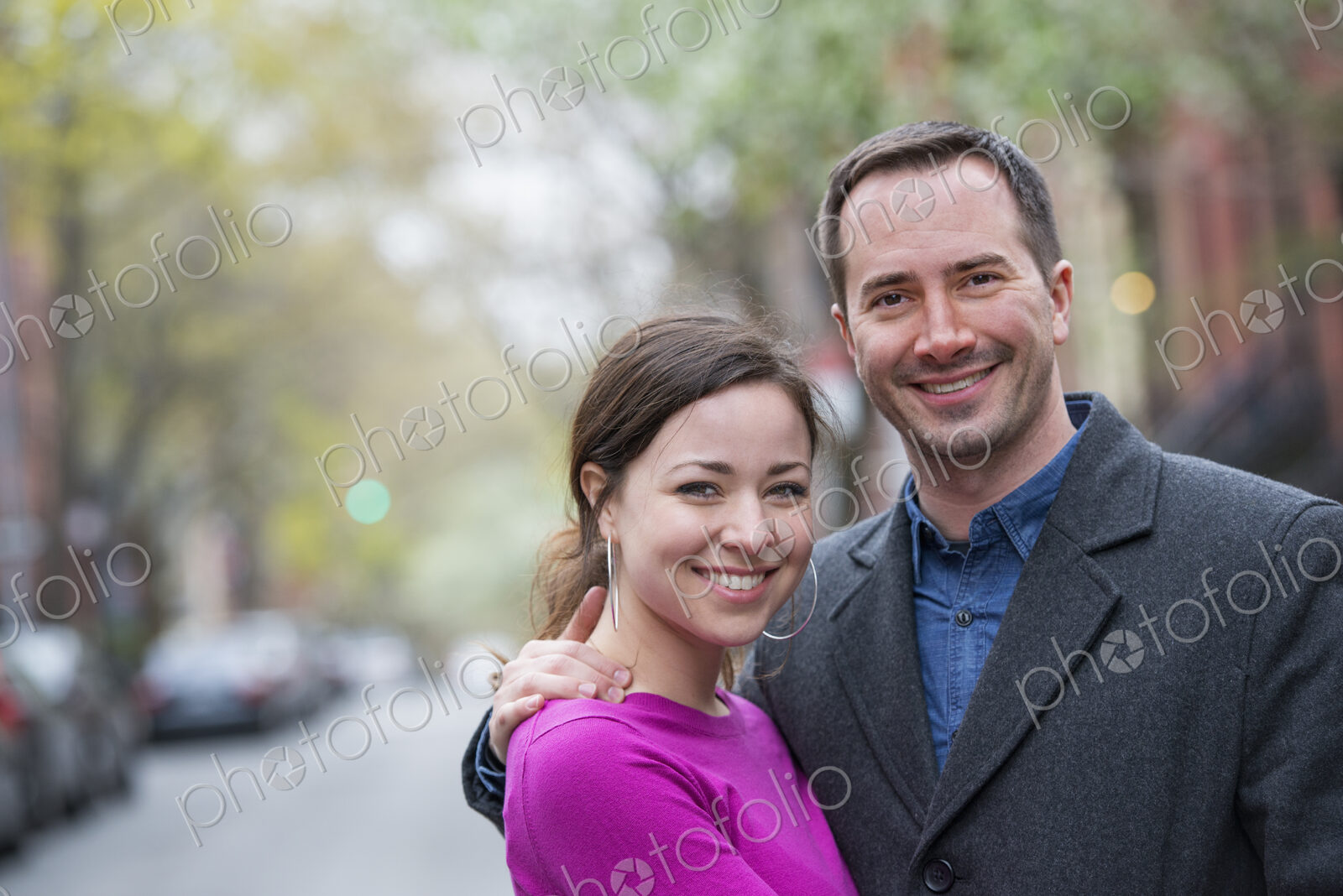 A couple, a man and woman side by side on a city street.