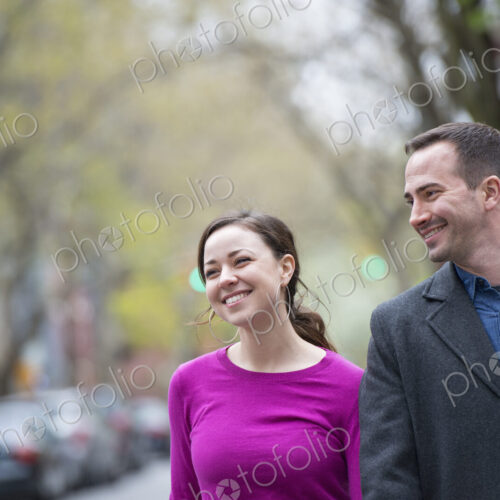 A couple, a man and woman side by side on a city street.