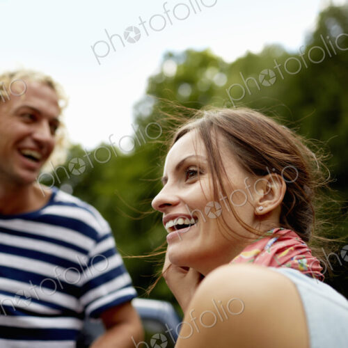 A couple, a young man and woman outdoors in woodland.