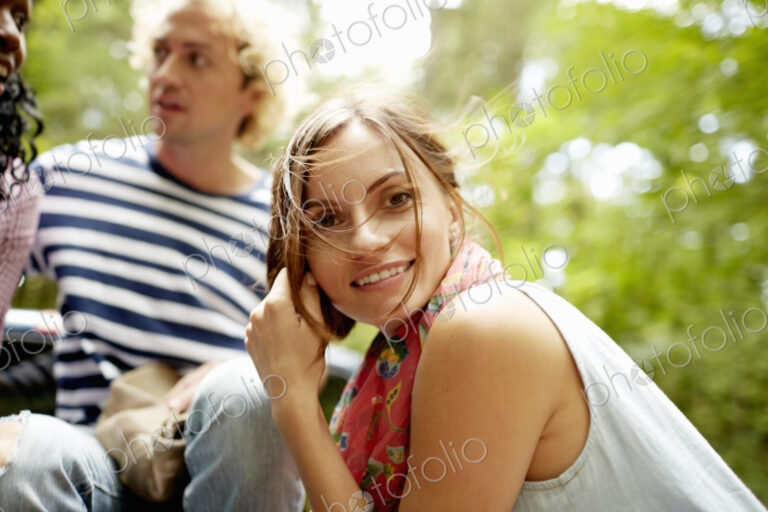 A couple, a young man and woman outdoors in woodland.