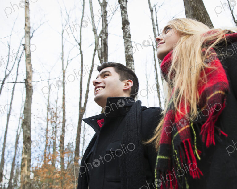 A couple in winter coats outdoors on a winter's day.