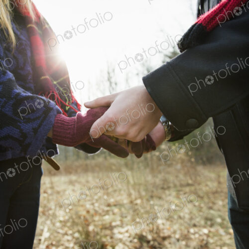 A couple in winter coats, outdoors on a winter's day. Holding hands. A couple in winter coats, outdoors on a winter's day. Holding hands.