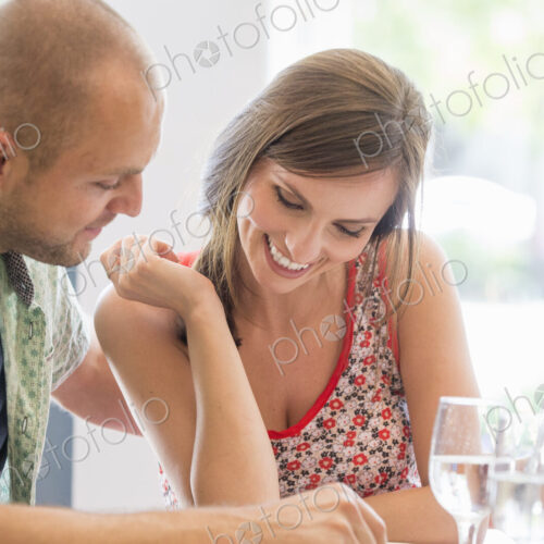 A couple, man and woman sitting in a restaurant looking at a menu. A couple, man and woman sitting in a restaurant looking at a menu.