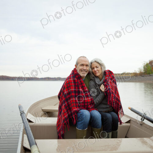 A couple, man and woman sitting in a rowing boat on the water on an autumn day.… A couple, man and woman sitting in a rowing boat on the water on an autumn day.…