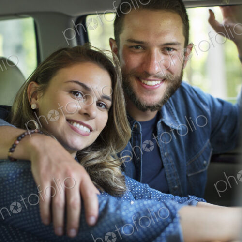 A couple, man and woman sitting inside a car. A couple, man and woman sitting inside a car.