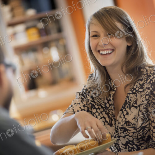 A couple sitting in a coffeeshop smiling and talking over a cup of coffee. A couple sitting in a coffeeshop smiling and talking over a cup of coffee.