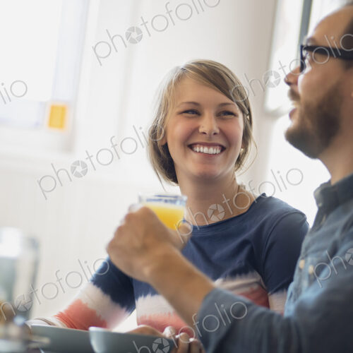 A couple sitting in a coffeeshop smiling and talking over a cup of coffee. A couple sitting in a coffeeshop smiling and talking over a cup of coffee.