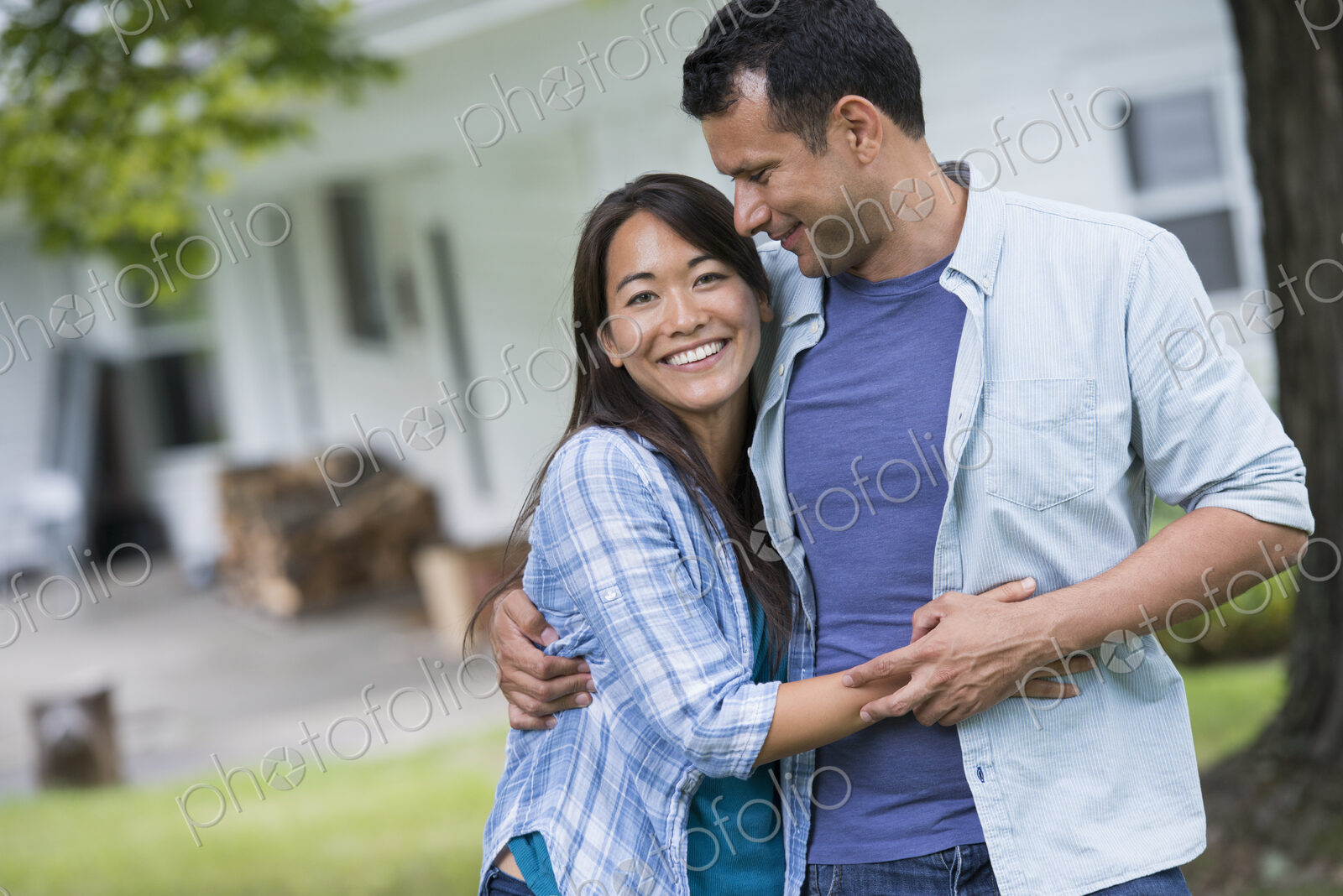 A couple standing with arms around each other.