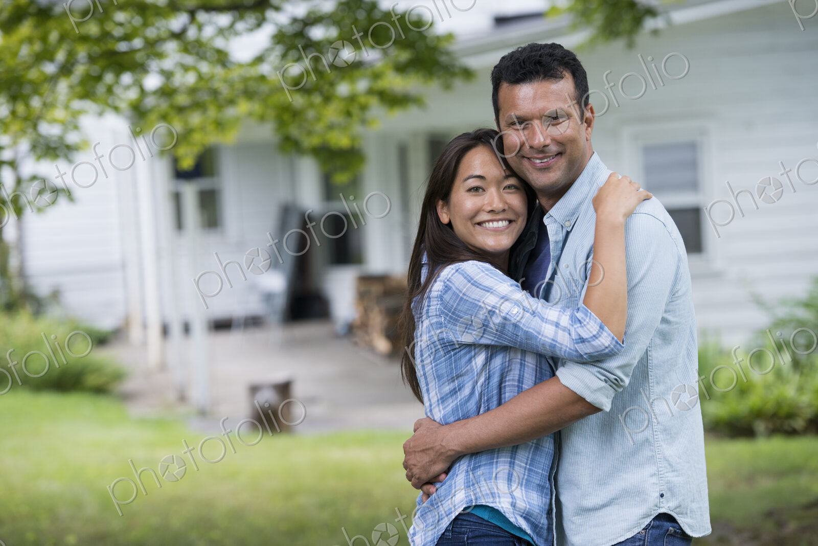 A couple standing with arms around each other.