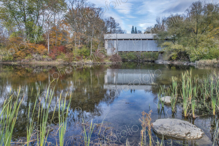 A covered bridge across a river in autumn.