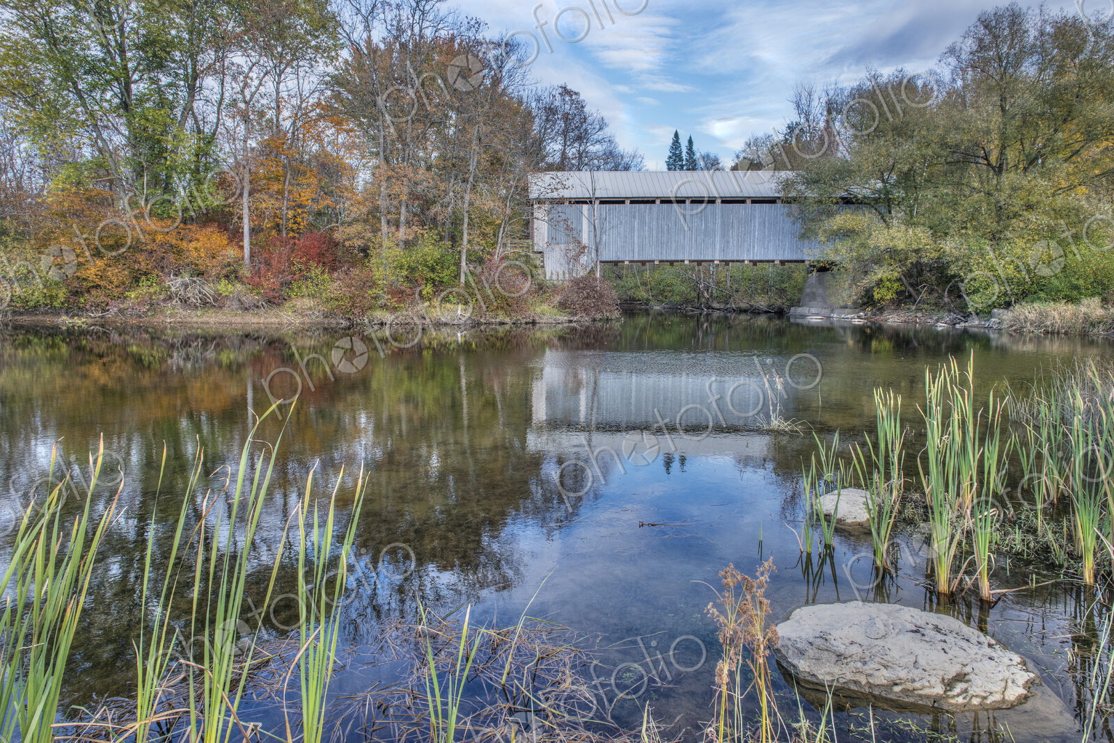 A covered bridge across a river in autumn.