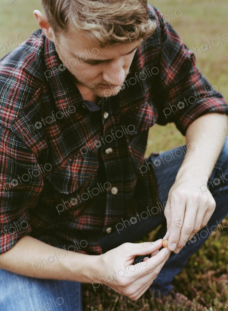 A cranberry farm in Massachusetts. Crops in the fields. A young man working on the…