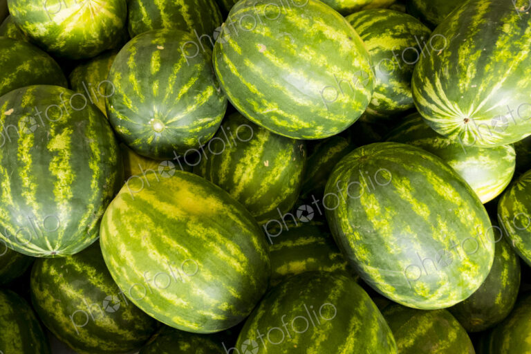 A crate of green and yellow water melons, Citrullus lanatus.