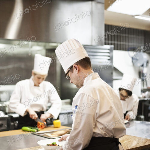 A crew of chef's working in a commercial kitchen, A crew of chef's working in a commercial kitchen,