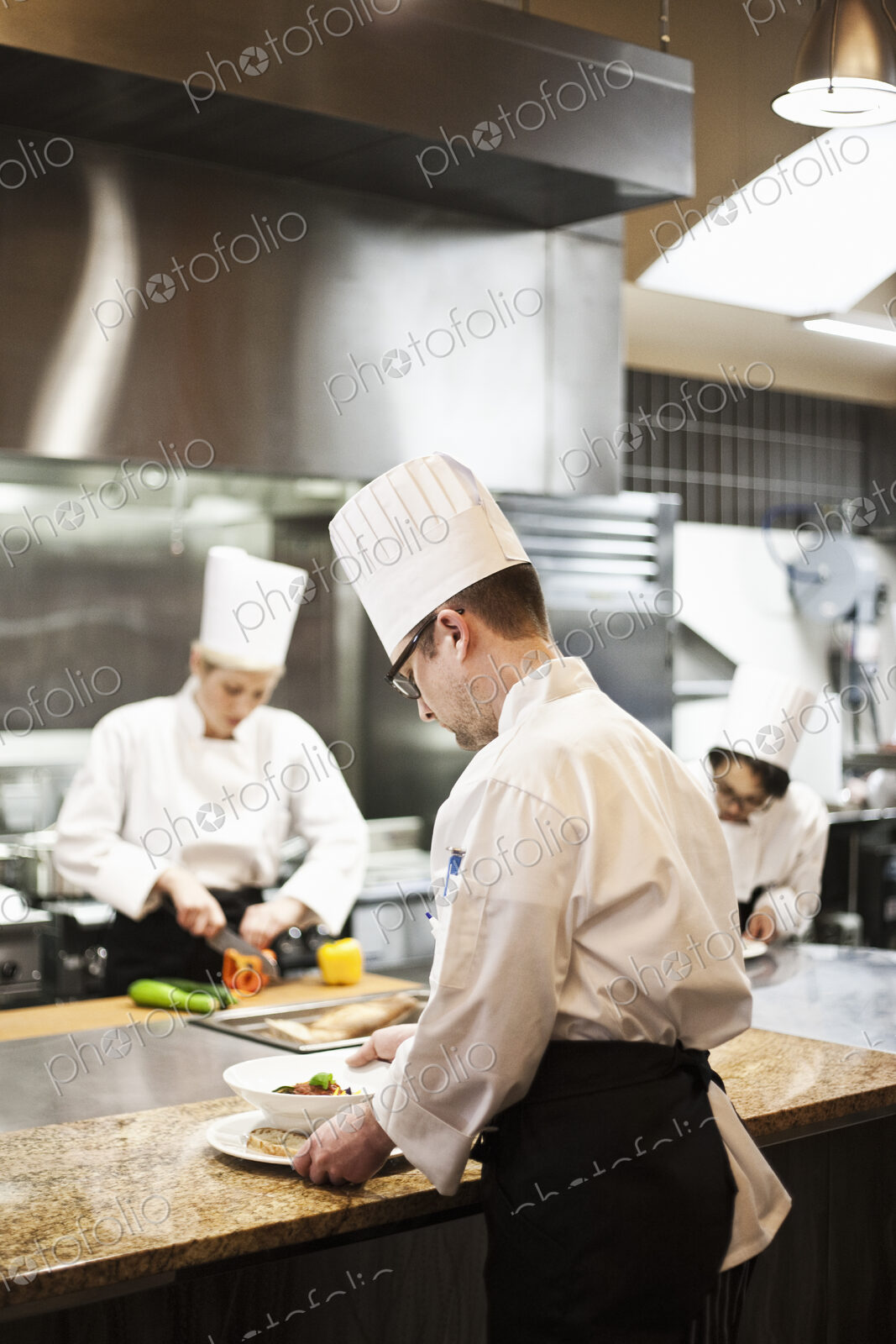 A crew of chef’s working in a commercial kitchen,