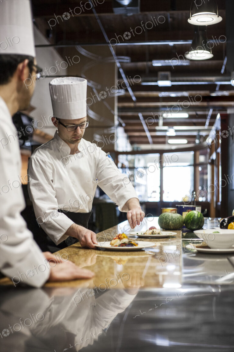 A crew of chef's working in a commercial kitchen,