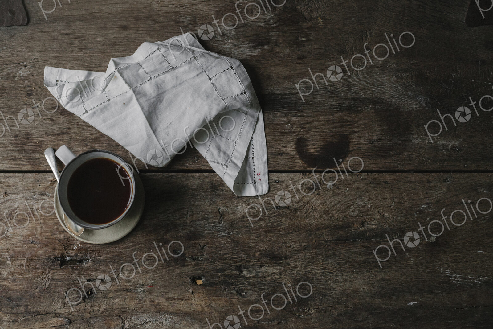 A cup of coffee and a napkin on a table.