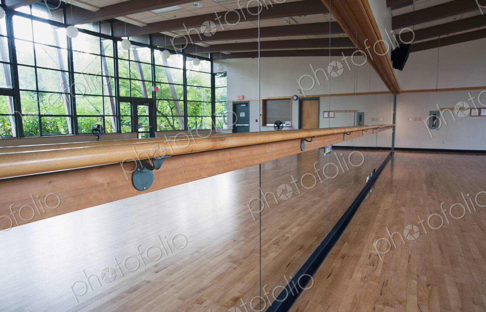 A dance or ballet studio,with a sprung wooden floor. Barre and wall mirrors