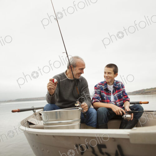 A day out at Ashokan lake. A man and a boy sitting fishing from the boat.