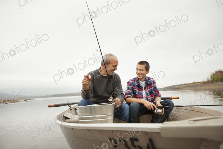 A day out at Ashokan lake. A man and a boy sitting fishing from the boat.