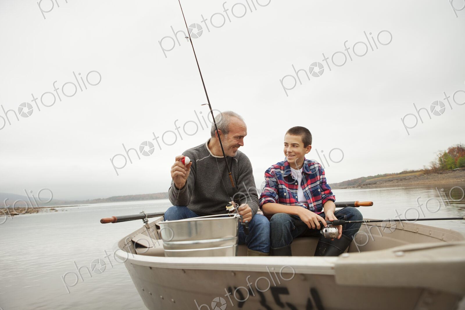 A day out at Ashokan lake. A man and a boy sitting fishing from the boat.