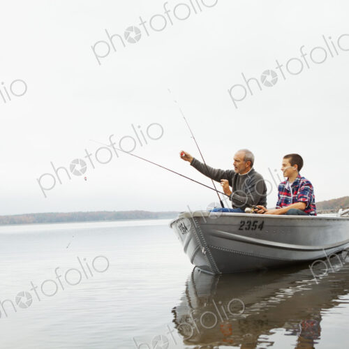 A day out at Ashokan lake. A man and a teenage boy fishing from a boat.