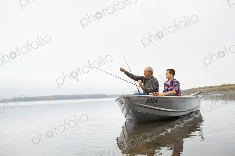 A day out at Ashokan lake. A man and a teenage boy fishing from a boat.