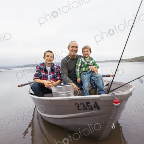 A day out at Ashokan lake. A man and two boys fishing from a boat.