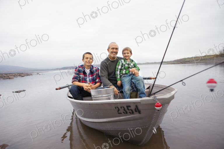 A day out at Ashokan lake. A man and two boys fishing from a boat.