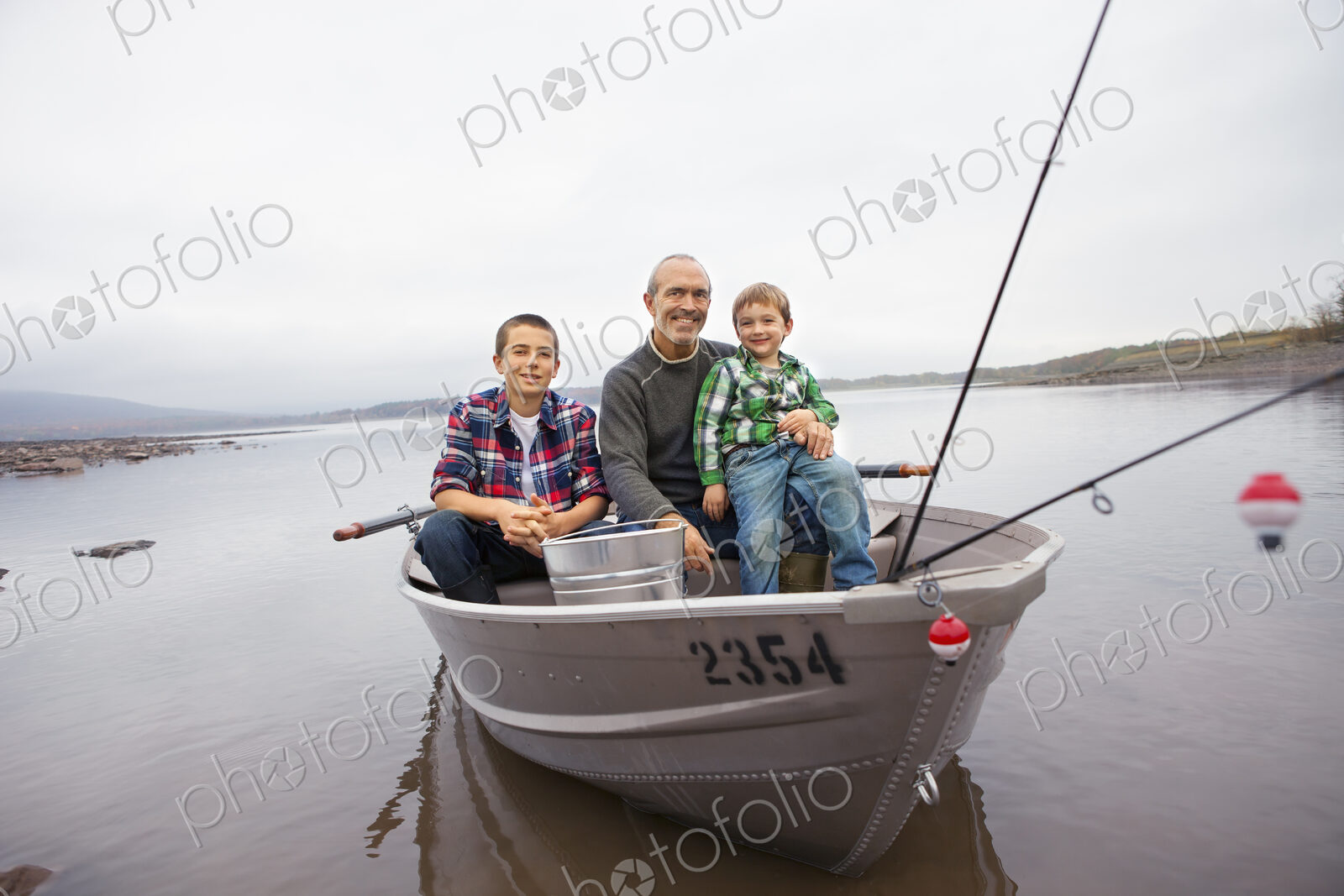 A day out at Ashokan lake. A man and two boys fishing from a boat.