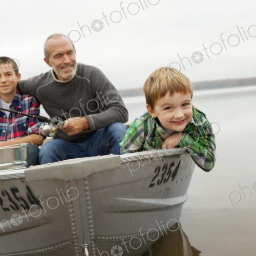 A day out at Ashokan lake. A man and two boys fishing from a boat.