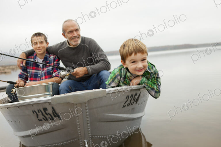 A day out at Ashokan lake. A man and two boys fishing from a boat.