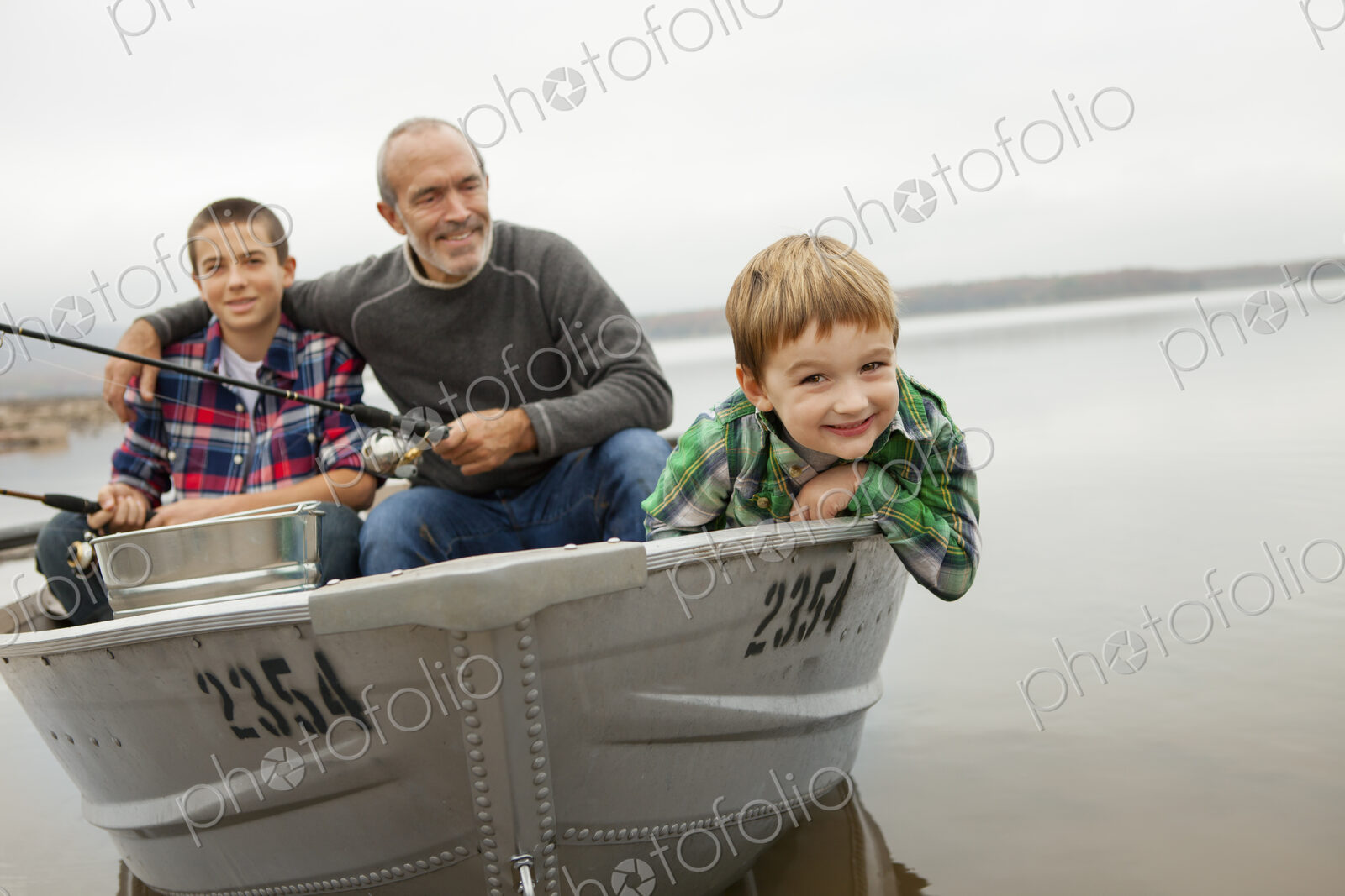 A day out at Ashokan lake. A man and two boys fishing from a boat.