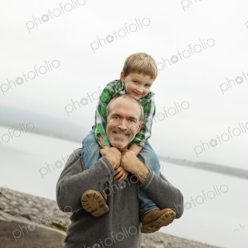 A day out at Ashokan lake. A man giving a child a shoulder ride.