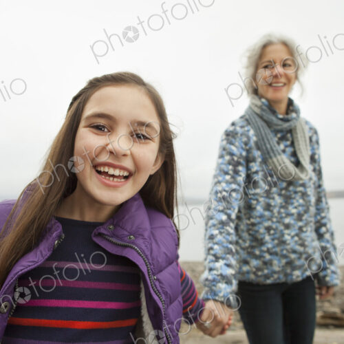 A day out at Ashokan lake. A mature woman holding hand with a young girl. A day out at Ashokan lake. A mature woman holding hand with a young girl.