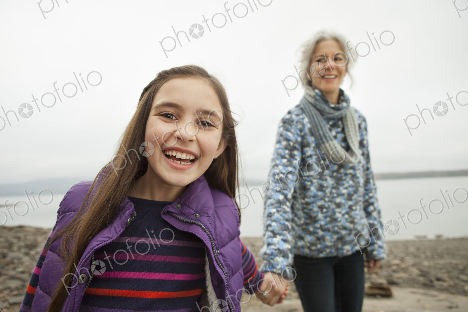 A day out at Ashokan lake. A mature woman holding hand with a young girl.