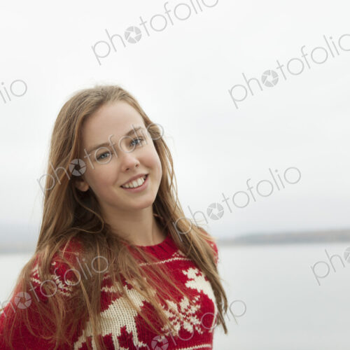 A day out at Ashokan lake. A young girl in a red winter knitted jumper. A day out at Ashokan lake. A young girl in a red winter knitted jumper.