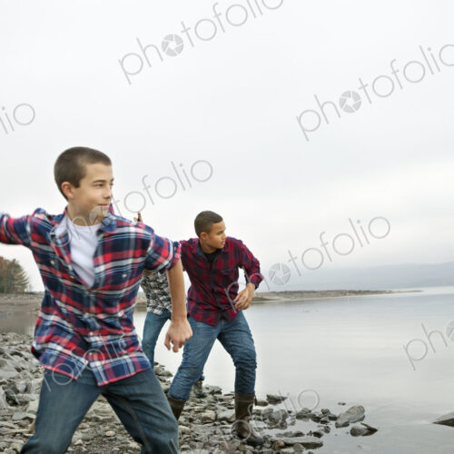 A day out at Ashokan lake. Three boys on the shore throwing skimmers pebbles across… A day out at Ashokan lake. Three boys on the shore throwing skimmers pebbles across…
