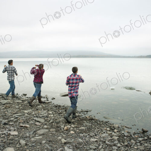 A day out at Ashokan lake. Three boys on the shore throwing skimmers pebbles across… A day out at Ashokan lake. Three boys on the shore throwing skimmers pebbles across…