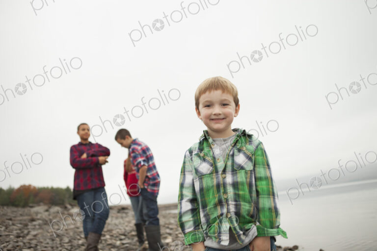 A day out at Ashokan lake. Three teenagers and a young boy on shore.