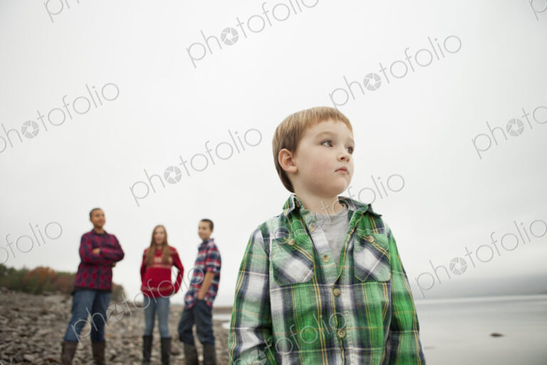 A day out at Ashokan lake. Three teenagers and a young boy on shore.