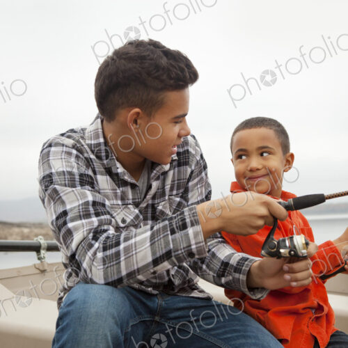 A day out at Ashokan lake. Two boys fishing from a boat.