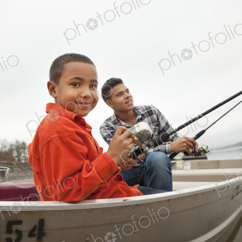 A day out at Ashokan lake. Two boys fishing from a boat.