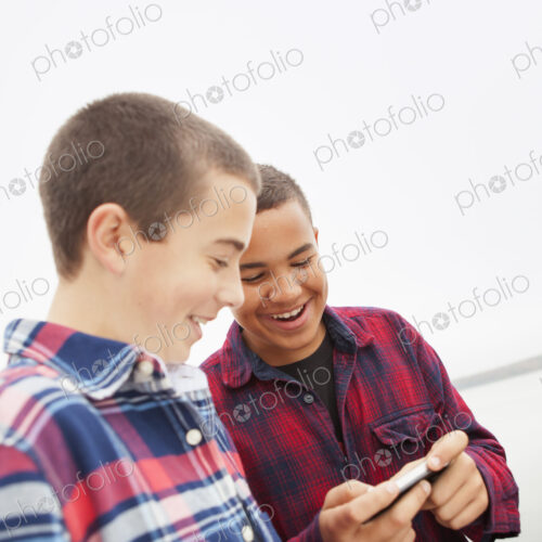 A day out at Ashokan lake. Two boys looking at a cell phone screen. A day out at Ashokan lake. Two boys looking at a cell phone screen.