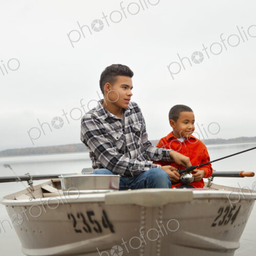A day out at Ashokan lake. Two boys sitting fishing from a boat.
