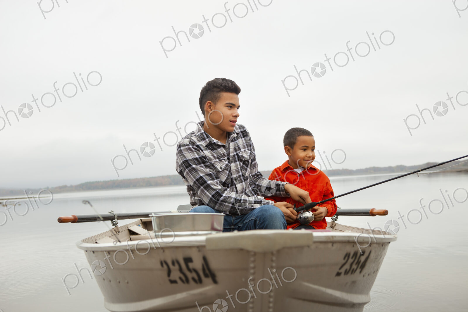 A day out at Ashokan lake. Two boys sitting fishing from a boat.