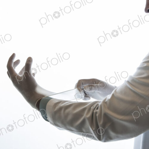 A dentist pulling on a medical examination glove. A dentist pulling on a medical examination glove.