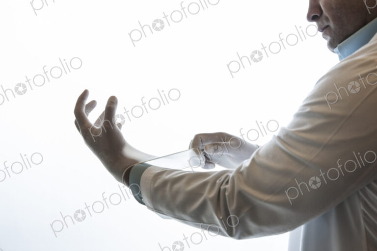A dentist pulling on a medical examination glove.